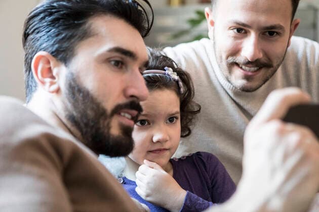 Fathers with curious daughter looking at smart phone while sitting at home , model released, property released Copyright: xMaskotx , MA64227