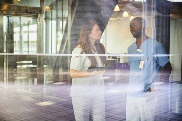 Nurses discussing seen through window glass at hospital , model released, property released Copyright: xMaskotx , MA65360
