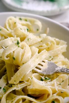 Cooked tagliatelle pasta with pesto sauce on fork Copyright: xIvettexAndxCox Model Released