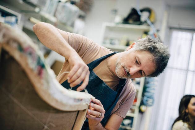 Mature craftsperson stitching furniture in workshop , model released, property released Copyright: xMaskotx , MA67729