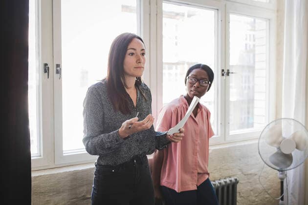 Businesswoman looking at colleague explaining strategy during meeting in creative office , model released, property released Copyright: xMaskotx , MA67801