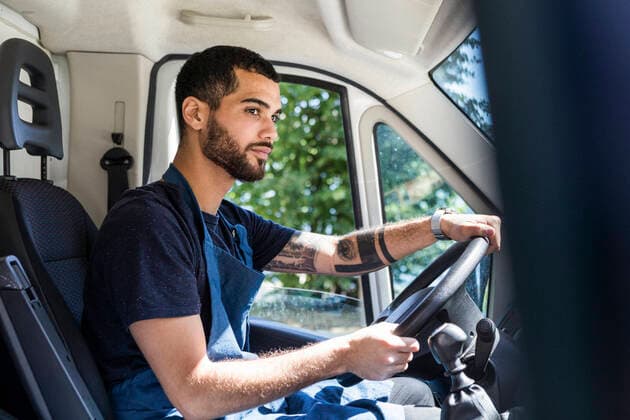 Side view of confident young male owner driving food truck in city , model released, property released Copyright: xMaskotx , MA68167