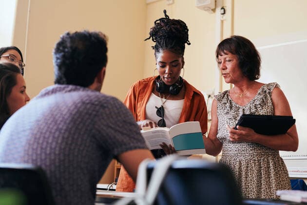 Teacher assisting students in language school , model released, property released Copyright: xMaskotx , MA68318