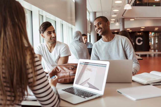 Multi-ethnic students discussing while studying together at university cafeteria , model released, property released Copyright: xKentarooxTrymanx , MA68413