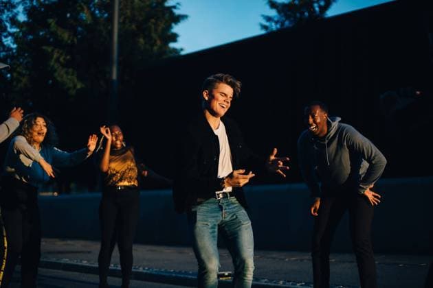 Happy male and female friends dancing in city at sunset , model released Copyright: xMaskotx , MA68463