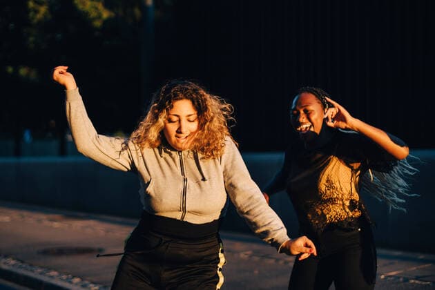 Excited friends dancing at skateboard park during sunset , model released Copyright: xMaskotx , MA68464