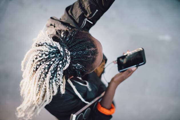 IMAGO Creative: Sport Start-Up High angle view of teenage girl with dreadlocks dancing while holding smart phone at skateboard park , model released Copyright: xMaskotx , MA68503