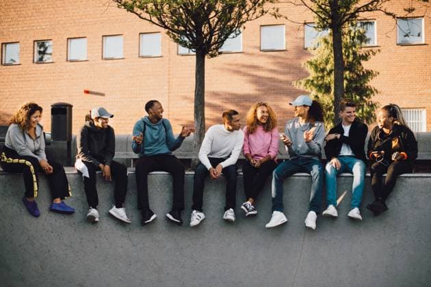 Full length of multi-ethnic friends sitting at skateboard park , model released Copyright: xMaskotx , MA68507