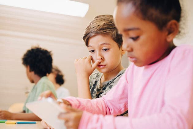 Boys using digital tablet while learning at classroom , model released, property released Copyright: xMaskotx , MA70219