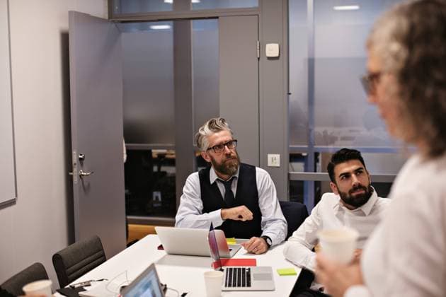 Serious businessmen listening in meeting at board room , model released, property released Copyright: xMaskotx , MA70907