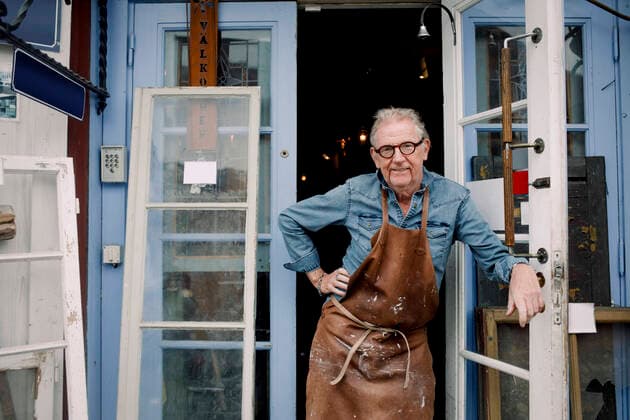 Portrait of senior hardware store owner standing with hand on hip while leaning on door , model released, property released Copyright: xMaskotx , MA73215