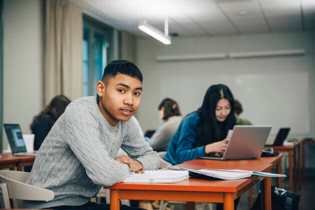 Portrait teenage boy sitting at desk in classroom , model released, property released Copyright: xMaskotx , MA73281
