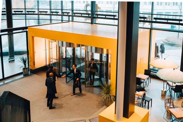 High angle view of business colleagues greeting while entering in office , model released, property released Copyright: xMaskotx , MA73616