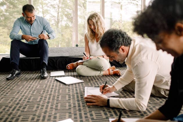 IMAGO Creative: Bildung, Schreiben Male and female business professionals writing on papers in convention center , model released, property released Copyright: xMaskotx , MA73848