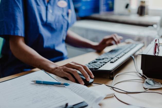 Midsection of nurse using computer at desk in hospital , model released, property released Copyright: xMaskotx , MA73913