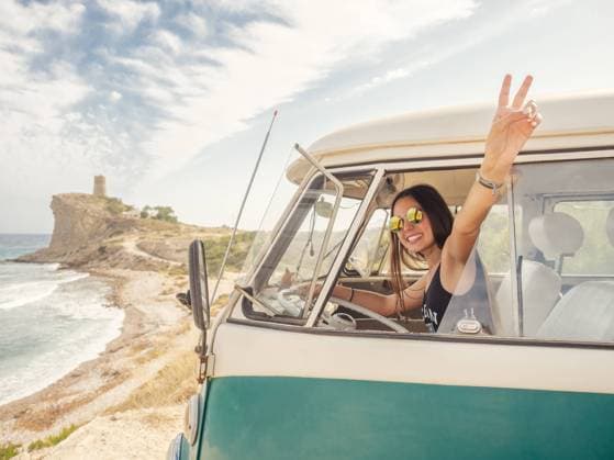 Side view of car with woman drawing on sandy empty beach with foamy waves in bright sunny day Copyright: xJavierxDexLaxTorrex Model Released