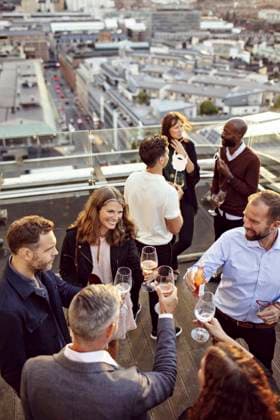 High angle view of coworkers toasting wineglasses while partying at building terrace , model released, property released Copyright: xMaskotx , MA74830