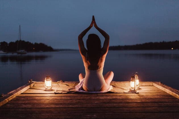 Rear view of woman practicing yoga while sitting on pier by sea against sky , model released, property released Copyright: xMaskotx , MA76435