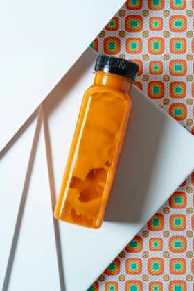 Mango and pumpkin smoothie bottle over retro style geometric textures. From above, Model released, Property released Copyright: xJayxMidx MR