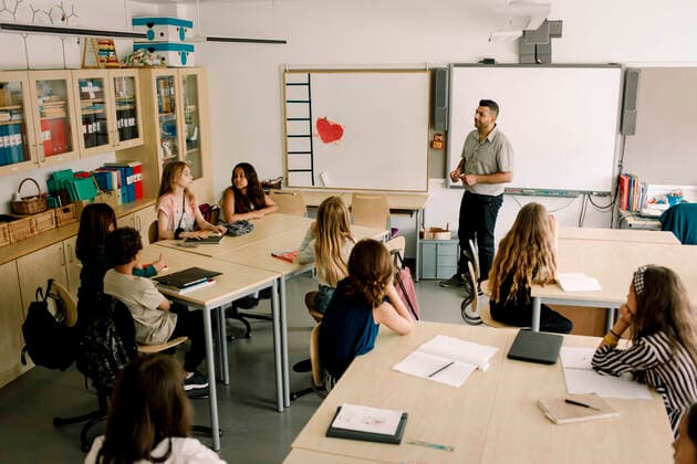 Male tutor teaching students in classroom , model released, property released Copyright: xMaskotx , MA77667