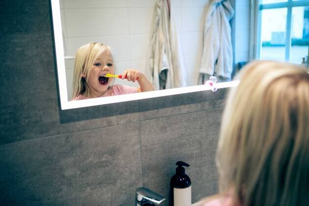 Reflection of girl brushing teeth seen on bathroom mirror , model released, property released Copyright: xKentarooxTrymanx , MA77727