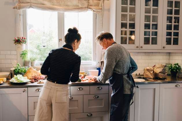 IMAGO Creative: Clickbait, Rezepte und Kochen Active female and male senior friends cutting watermelon at counter in kitchen Sweden, Stockholm, model released, property released Copyright: xMaskotx , MA80030