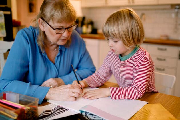 IMAGO Creative: Bildung, Schreiben Grandmother assisting grandson in studying at home Sweden, Stockholm, model released, property released Copyright: xMaskotx , MA80263