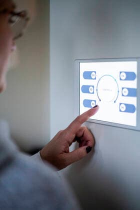 Woman using digital tablet on wall at modern home Sweden, Stockholm, model released, property released Copyright: xMaskotx , MA80388