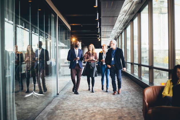 Smiling female and male colleagues walking in office corridor Sweden, Stockholm, model released, property released Copyright: xMaskotx , MA80677