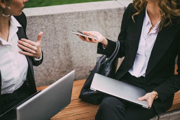 Midsection of female entrepreneurs communicating while sitting in city Sweden, Stockholm, model released Copyright: xMaskotx , MA81328
