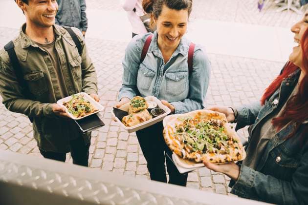 Male and female customers with food plate standing in city Sweden, Stockholm, model released, property released Copyright: xMaskotx , MA81623