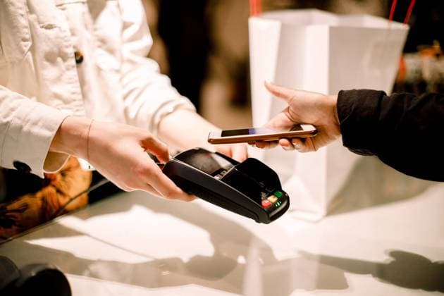Cropped hand of female customer paying through smart phone at store Sweden, Stockholm, model released, property released Copyright: xMaskotx , MA81766
