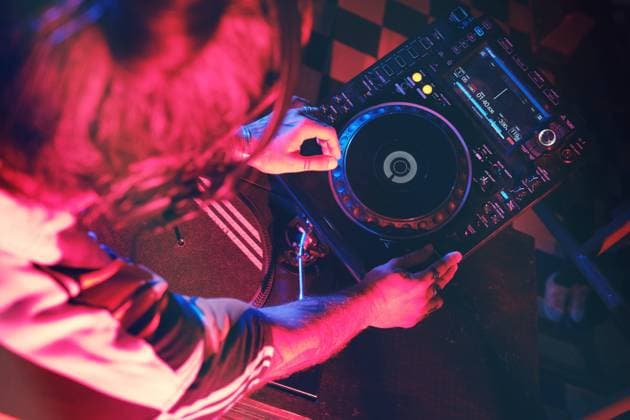 From above an anonymous dj man playing in a club with lights Copyright: xPhilippexDegrootex Model Released