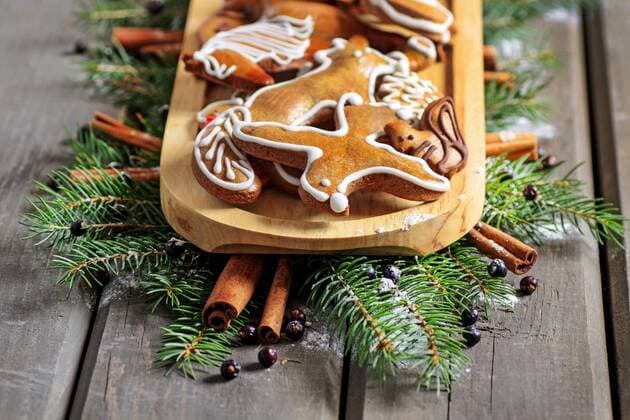 Gingerbread cookies on wooden tray among fir branches. Christmas sweets  BEW1D90E27C