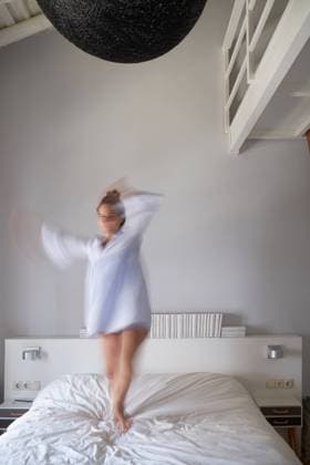Blurred woman jumping on bed, Model released Copyright: xCienxXxCienxStudiox MR