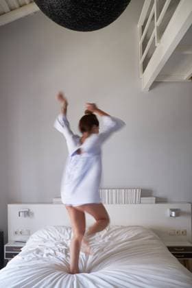 Blurred woman jumping on bed, Model released Copyright: xCienxXxCienxStudiox MR