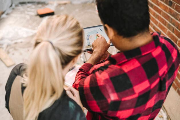 High angle view of man pointing at digital tablet by female partner outside house Sweden, Stockholm, model released, property released Copyright: xMaskotx , MA83130
