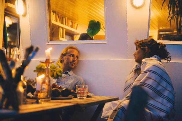 Couple talking while having candlelight dinner on houseboat Sweden, Stockholm, model released, property released Copyright: xMaskotx , MA83504