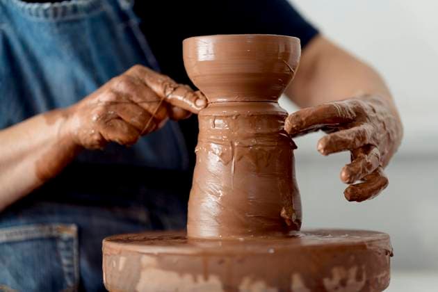Mature female artist making pottery from clay at workshop model released Symbolfoto property released EGAF01184