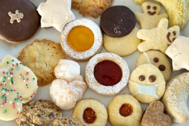Various ready-to-eat Christmas cookies, one wearing protective face mask ELF02308