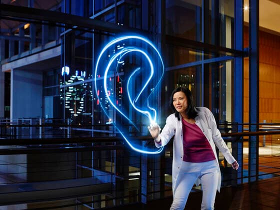 Female otolaryngologist examining ear with light painting in laboratory at hospital model released Symbolfoto property released RORF02498