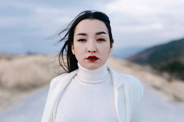 Sad woman staring while standing against sky model released Symbolfoto TCEF01418