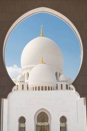 Sheikh Zayed Grand Mosque, Abu Dhabi, United Arab Emirates. Sheikh Zayed Grand Mosque in Abu Dhabi, United Arab Emirates.mosque, abu dhabi, sheikh zayed mosque, uae, islam, marble, middle east, window, architecture, grand, muslim, sheikh, zayed, religion, emirates, United Arabic Emirates, arabian, asia, dome, religious, worship, temple, sky, exterior, landmark, pillars, minaret, design, prayer, holy, arab, sunlight, belief, islamic, sultan, worshiping, sacral, famous, white, blue, dubai, art, travel, tourism, tourist, building, couryard, entranse, detail, entrance, 