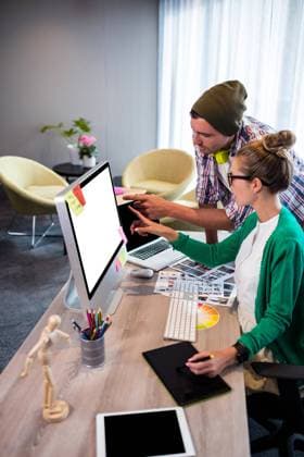 Casual colleagues using technology Casual colleagues using technology in the office, model released30s, Mid Adult, Woman, Female, Caucasian, 20s, Young Adult, Man, Male, Office, Workplace, Desk, Bureau, Creative, Casual Clothing, Colleagues, Team, Creative Office, Job, Career, Profession, Professional, Agency, Company, Business, Occupation, Stylish, Hip, Hipster, Cool, Trendy, Beautiful, Handsome, Editor, Graphic Designer, Design, Electronic, Laptop, Notebook, Computer, Pc, Graphic Tablet, Drawing, Wireless, Technology, Sign, Finger, Showing, Pointing, Gesture, Hand, Presenting, Concentrated, Thoughtful, Attentively, Focused, Wearing, Hat, Glasses 