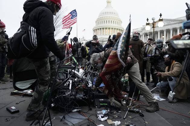 Pro-Trump rioters destroy camera gear and media equipment after breaching the security perimeter and penetrate the U.S. Capitol to protest against the Electoral College vote count that would certify President-elect Joe Biden as the winner in Washington, DC on Wednesday, January 6, 2021. Under federal law, Jan. 6 is the date Electoral College votes determining the next president are counted in a joint session of Congress.  WAP2021010602 KenxCedeno