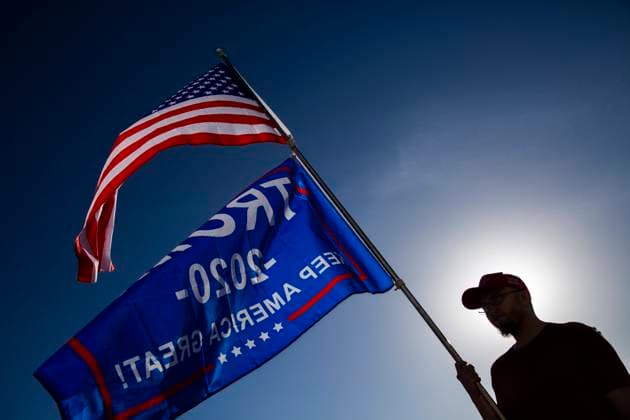 January 6, 2021, Salt Lake City, Utah, USA: A President Trump supporter waves flags during the Stop The Steal Rally at the Utah State Capitol in Salt Lake City, Utah on January 06, 2021. President Trump supporters gathered in the nation s capital today to protest the ratification of President-elect Joe Biden s Electoral College victory over Trump in the 2020 election. In Washington, DC Trump s supporters stormed a session of Congress held today, January 6, to certify Joe Biden s election win, triggering unprecedented chaos and violence at the heart of American democracy and accusations the president was attempting a coup. Salt Lake City USA - ZUMAc244 20210106_zip_c244_020 Copyright: xDanielxCardex