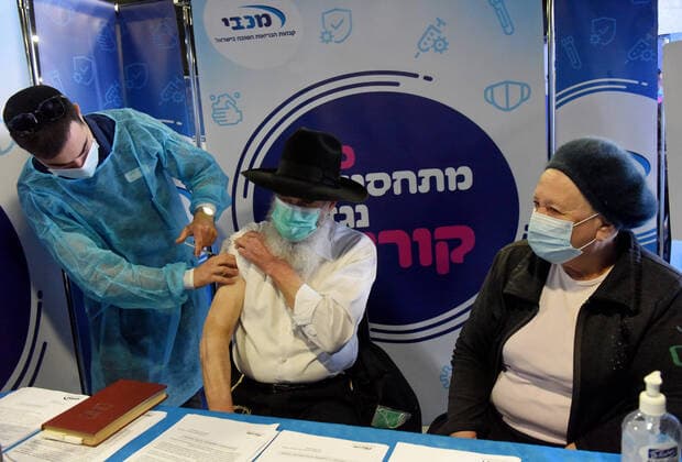 An Ultra-Orthodox Jew receives his second shot of the Pfizer- BioNTech COVID-19 vaccine in an Israeli vaccination center in Jerusalem, on Tuesday, January 12, 2021. Israel will expand the vaccination drive inoculating teachers and people over 50 years on Wednesday.  JER2021011203 DEBBIExHILL