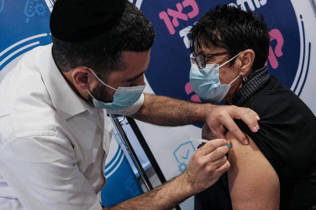 January 14, 2021, Jerusalem, Israel: Nurses administer COVID-19 vaccines at the Pais Arena Sports Complex in Jerusalem, converted into a Coronavirus vaccination center. Criteria is now either health workers, education workers, or the general public 50 years of age and above. The number of Israeli citizens who have received at least one dose of the Pfizer BioNTech vaccine has exceeded 2M as a mass vaccination campaign continues, and so does COVID-19 infection in the general public. Jerusalem Israel - ZUMAa126 20210114_zap_a126_007 Copyright: xNirxAlonx