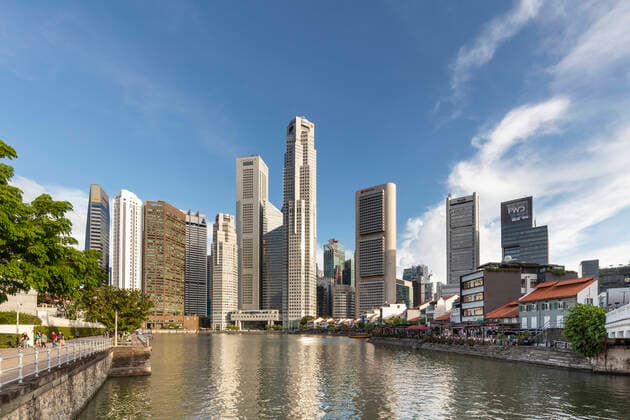 Skyscrapers in Singapore s CBD, adjacent to Boat Quay along the Singapore River. Towers such as OCBC Centre by I.M Pei and UOB Plaza by Kenzo Tange are illuminated by the sunset.  Copyright: xx