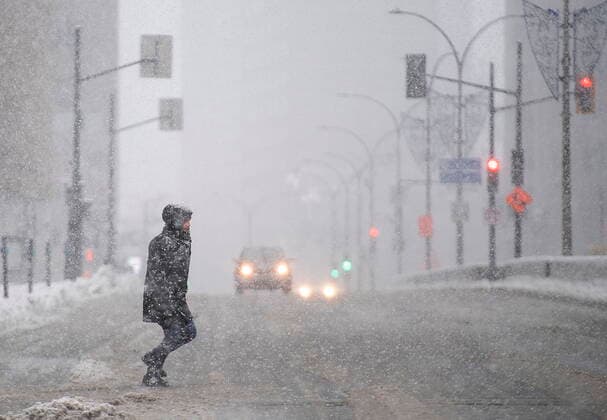 January 16, 2021, Montreal, PQ, Canada: A man crosses a street during a snowstorm in Montreal, Saturday, January 16, 2021. Montreal Canada  - ZUMAc35_ 20210116_zaf_c35_004 Copyright: xGrahamxHughesx